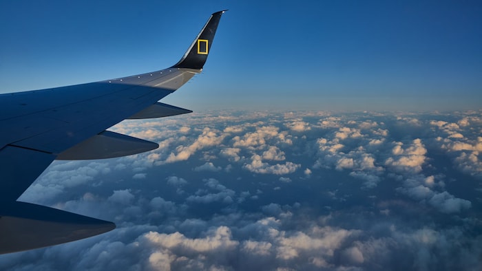 National Geographic private jet above the clouds